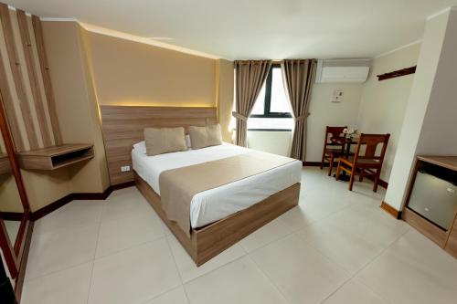 a bedroom with a bed and a television in it at Hostal Los Cactus in Lima