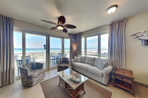 a living room with a couch and a ceiling fan at Beach Club #206A in Pensacola Beach