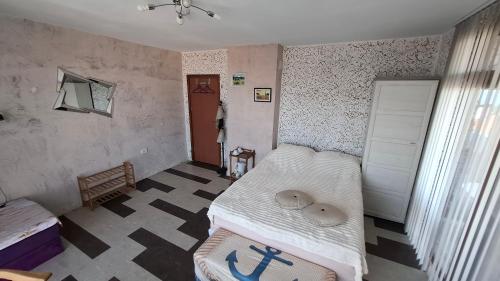 a bedroom with two beds and a window and a room with a bed sidx sidx at Magi Sunrise in Balchik