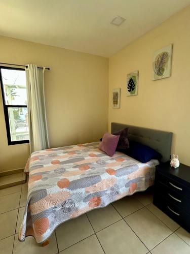 a bedroom with a bed with a dresser and a window at Estudio #5 a 5 min del malecon in La Paz