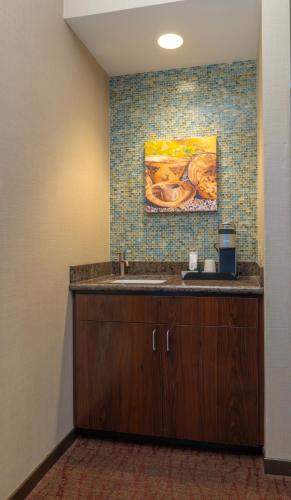 a bathroom with a sink and a painting on the wall at Win-River Resort and Casino in Redding