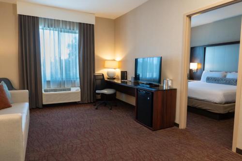 a hotel room with a bed and a desk with a television at Win-River Resort and Casino in Redding