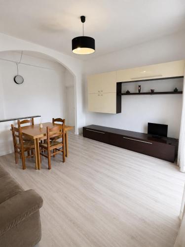 a living room with a table and chairs and a couch at Alessandro home in Rozzano