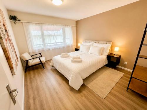 a bedroom with a large bed and a window at 3Br Topview Interlaken Mountain View Apartment in Unterseen