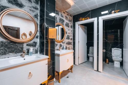 a bathroom with a sink and a mirror at Kremlin 1908 Hotel in Kars