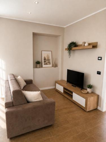 a living room with a couch and a flat screen tv at La Terrazza, comfort e relax tra i laghi in Borgomanero