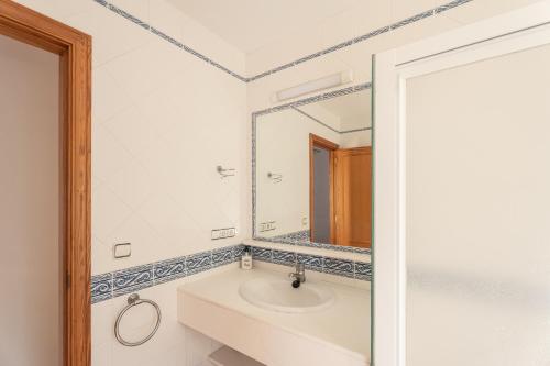 a bathroom with a sink and a mirror at V155 Villa Llebeig in Son Bou
