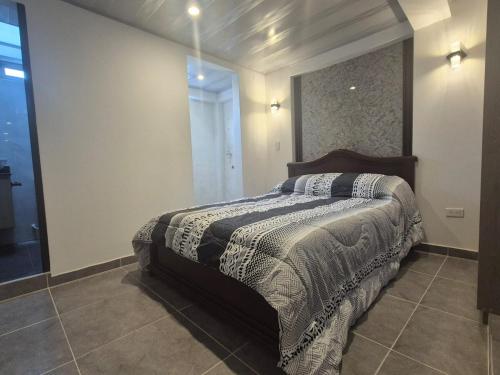 a bedroom with a bed and a large mirror at Park Suite in Ibagué