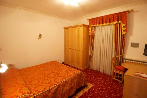 Postel nebo postele na pokoji v ubytování Hotel Belvedere Srl