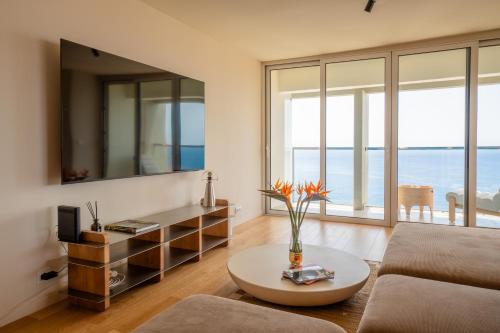 a living room with a couch and a table at Horizon living Madeira in Caniço