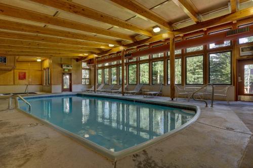 a swimming pool in a building with windows at Lodgepole #2003 in Keystone
