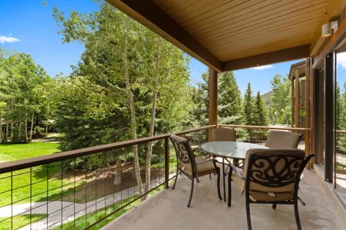 a patio with a table and chairs on a balcony at Lodgepole #2003 in Keystone