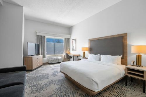 a hotel room with a large bed and a television at SpringHill Suites by Marriott Atlanta Kennesaw in Kennesaw