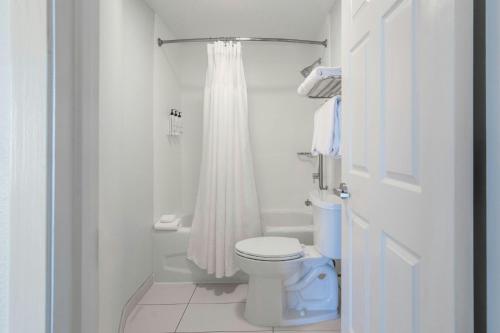 a white bathroom with a toilet and a shower at SpringHill Suites by Marriott Atlanta Kennesaw in Kennesaw