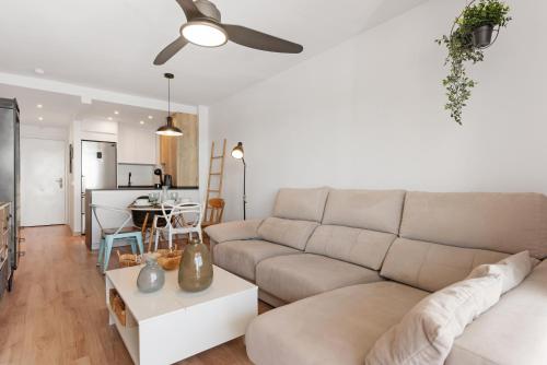 a living room with a couch and a table at APARTAMENT MIJAS BEACH, ÁNGEL in La Cala de Mijas