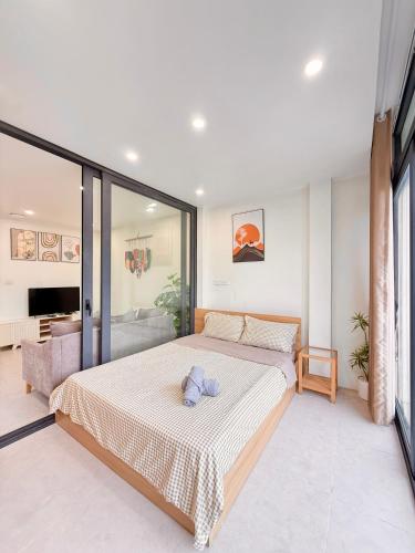 a bedroom with a bed with a teddy bear on it at Nest West Lake - Apartment Hà Nội in Hanoi