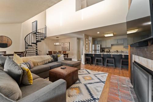 a living room with a couch and a table at Snowbridge Square #F206 in Copper Mountain