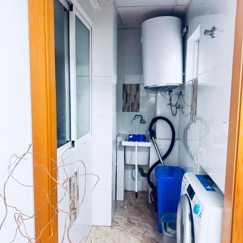 a bathroom with a sink and a washing machine at Veleta Montserrat - Alicante in Alicante