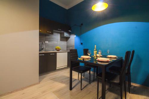 a kitchen and dining room with a table and chairs at Apartment Jasmin in Rijeka