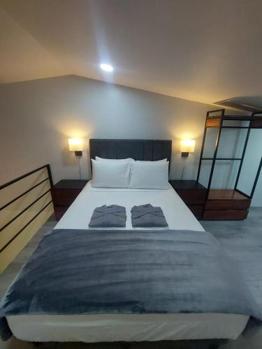 a bedroom with a large bed with two pillows on it at River Suite at Luna Negra Suites & Spa in El Castillo de La Fortuna