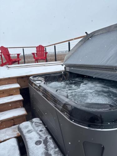 a hot tub on a deck in the snow at The Lantern Hill Lookout in North Rustico