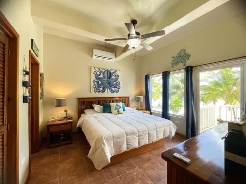 a bedroom with a bed and a ceiling fan at Sapphire Beach Resort in Basil Jones