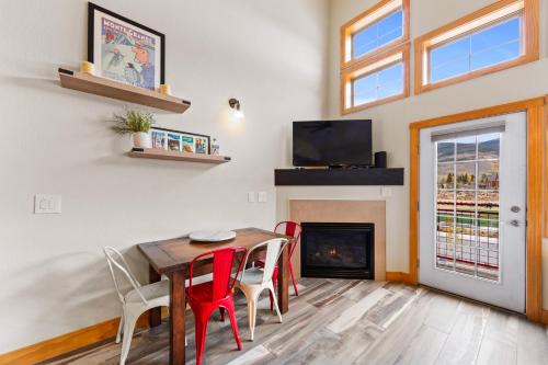 a dining room with a table and chairs and a fireplace at La Riva Del Lago #204 in Dillon