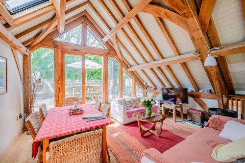 a living room with a table and a couch at Airy Barn Conversion Private Parking & Garden in Burrington
