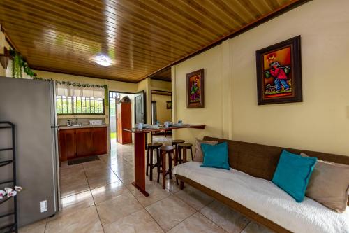 a living room with a couch and a table at Hormiga's Houses La Fortuna in Fortuna