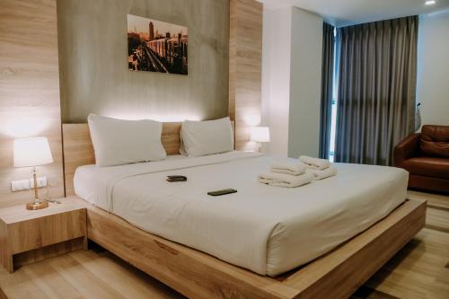 a bedroom with a large bed with two towels on it at Alpine Grande in Kathmandu