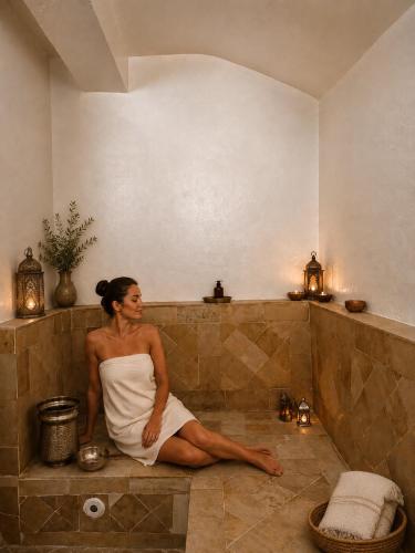 a woman is sitting in a bath tub at Alya Residence in La Marsa