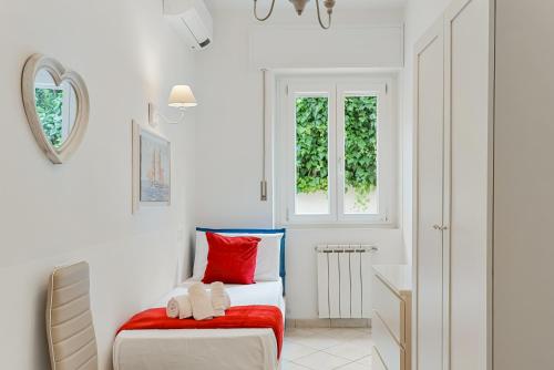 a white room with a bed and a window at GOLDEN LUXE - Sunset by the Sea in Lido di Camaiore