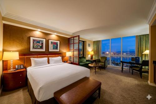 a hotel room with a large bed and a desk at MGM Signature 19-716 Jacuzzi Studio in Las Vegas