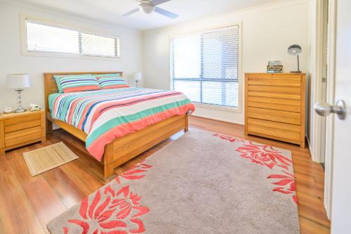 a bedroom with a bed and a dresser at Lomandra in Evans Head