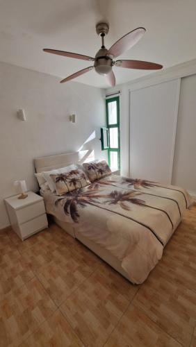 a bedroom with a bed and a ceiling fan at Lukite House in Tías