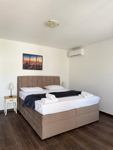 a bedroom with a large bed in a room at Apartments M&E in Mokošica