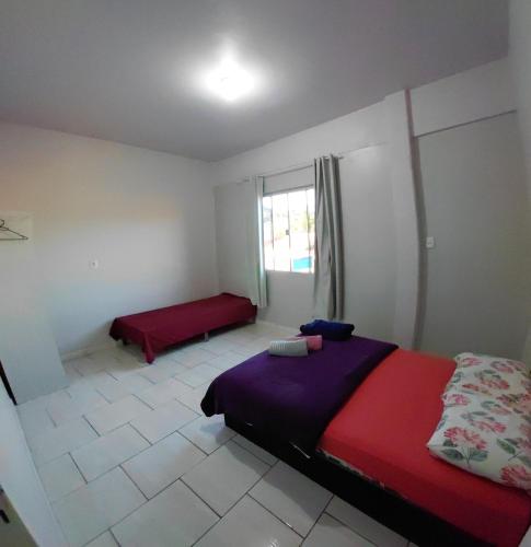 a bedroom with a bed and a window at Pousada Familiar 10 in Rio do Sul