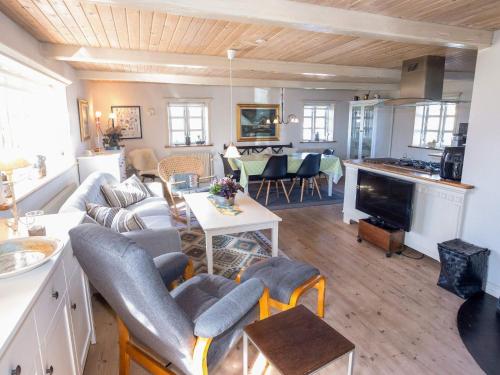 a living room with a couch and a table at 5 person holiday home in Øster Assels-By Traum in Øster Assels