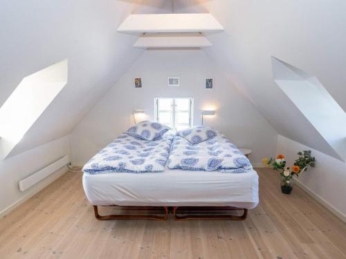 a bedroom with a large bed in a attic at 5 person holiday home in Øster Assels-By Traum in Øster Assels