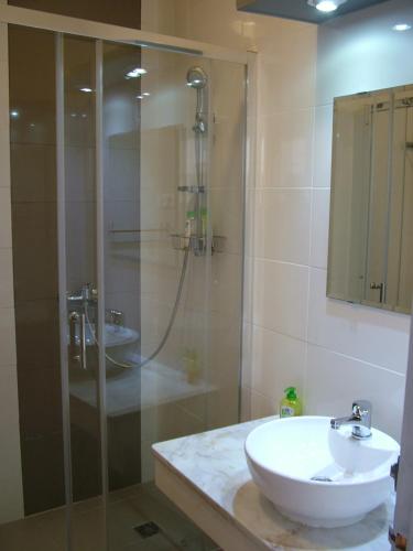 a bathroom with a glass shower and a sink at Casa dos Pedro´s in Vila Nova