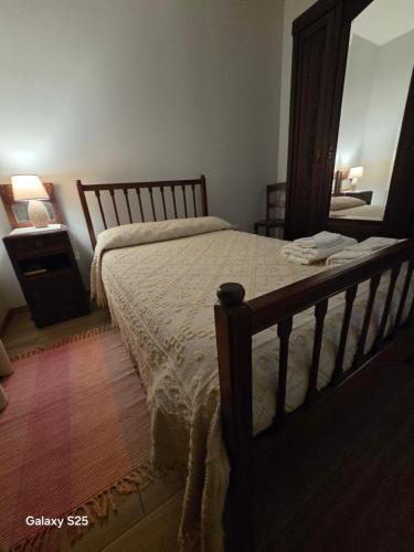 a bedroom with a bed and a dresser and a mirror at RECANTO da VONINHA in Castelo de Paiva