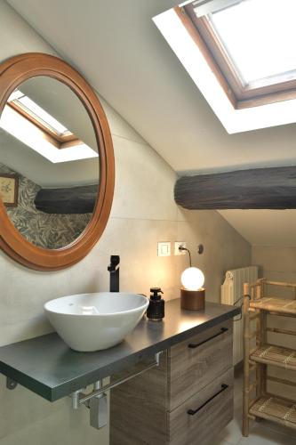 a bathroom with a bowl sink and a mirror at Casa Il Nido Bright Rooftop Nest in Lecco