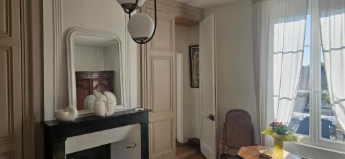 a living room with a fireplace and a mirror at Chez Mary in Larzicourt