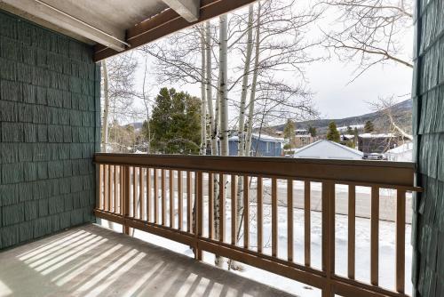 a balcony with a view of a snow covered yard at Tenmile Creek #215 : 2 in Frisco