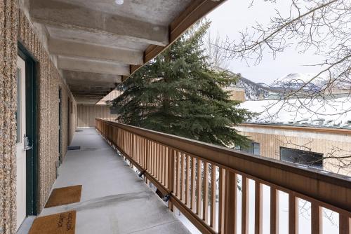 a balcony with a christmas tree on the side of a building at Tenmile Creek #215 : 2 in Frisco