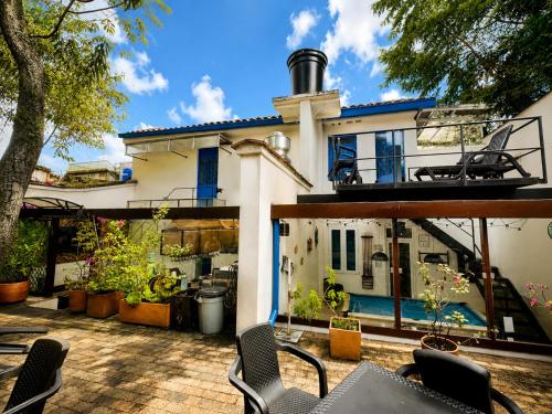 a house with a patio with tables and chairs at Granada Hostel in Bogotá