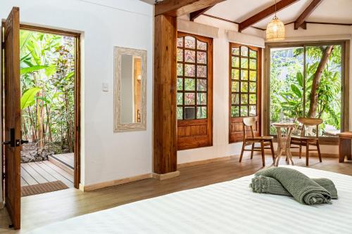 a bedroom with a bed and a table and chairs at Rapa Nui, La Residence in Hanga Roa