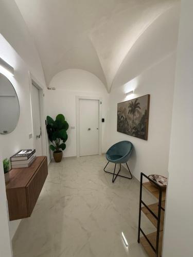 a living room with a table and a chair at La dimora del duomo boutique suites & rooms in Terrasini