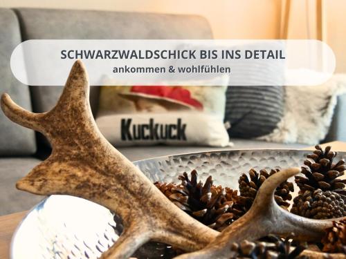 a table topped with a bowl of pine cones at FeWo Schwarzwaldschick Feldberg I Bergurlaub I Balkon I Whirlwanne I Tiefgarage I HochschwarzwaldCard inkl in Feldberg