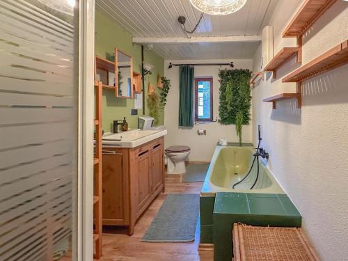 a bathroom with a tub and a sink and a toilet at Briedel in Briedel